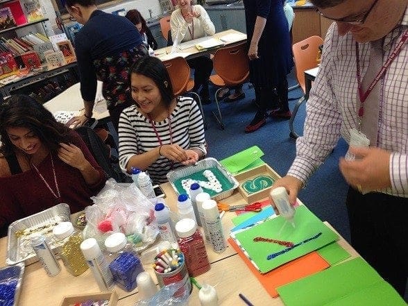 A group of mum women returners sitting around a table making crafts, while achieving work-life balance.
