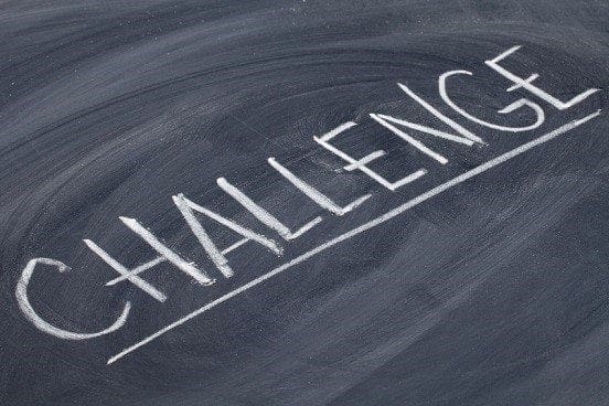 The word challenge written on a blackboard, representing the career and jobs working environment.
