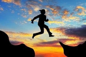 Woman jump over canyon
