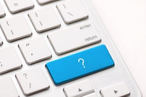 A computer keyboard with a blue question mark symbol.