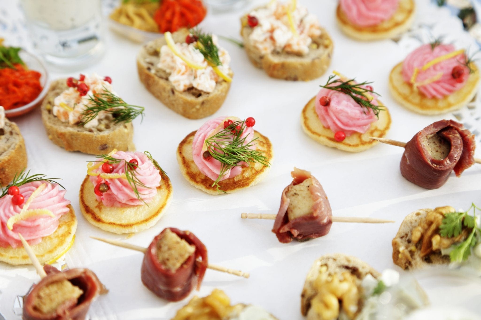 A tray of appetizers on a white plate, perfect for job interviews or working events.
