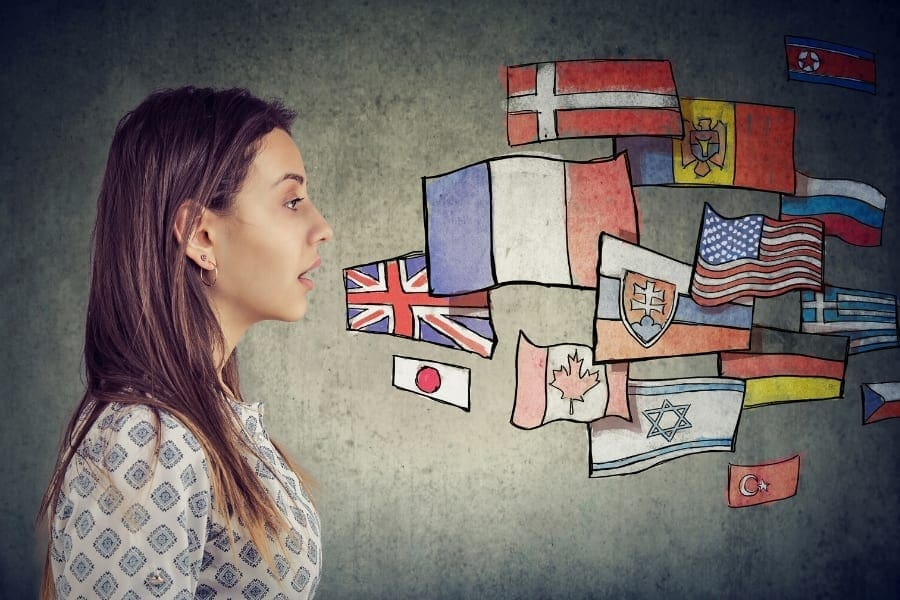 A woman is speaking in front of a wall with flags on it, sharing valuable insights on work-life balance for women returners.