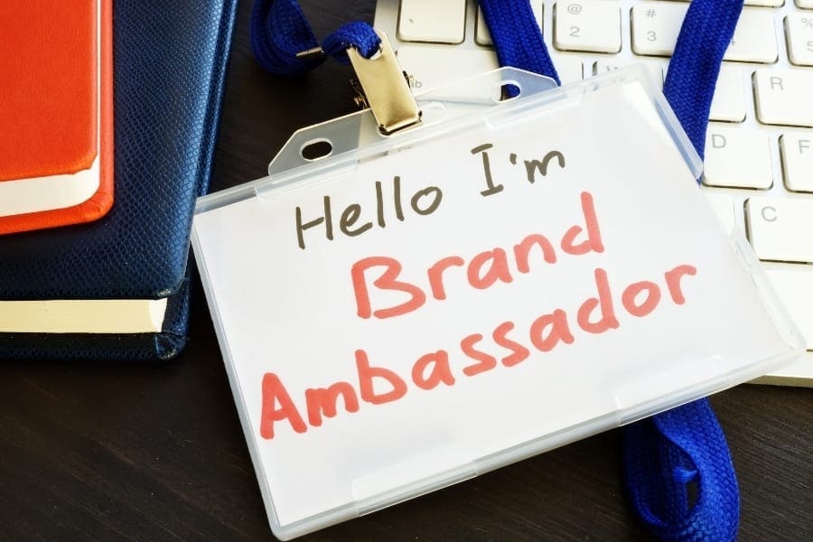 A brand ambassador sign displayed prominently on a desk, representing an exciting career opportunity with potential for great work-life balance.
