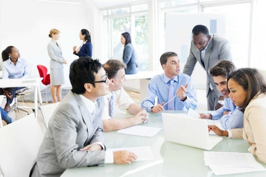 A group of business people working together around a table.