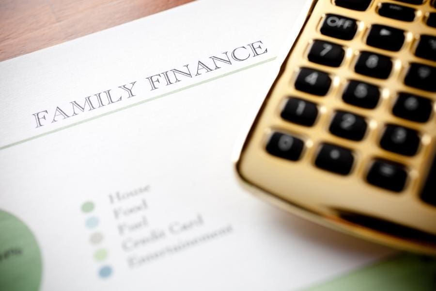 A calculator sits on top of a mum's family finance document, symbolizing work-life balance for women returners.