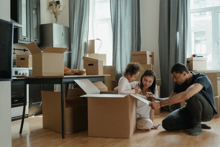 A family moving house and unpacking boxes in their new home.
