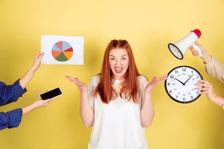 A woman is demonstrating time management with a megaphone and a clock.