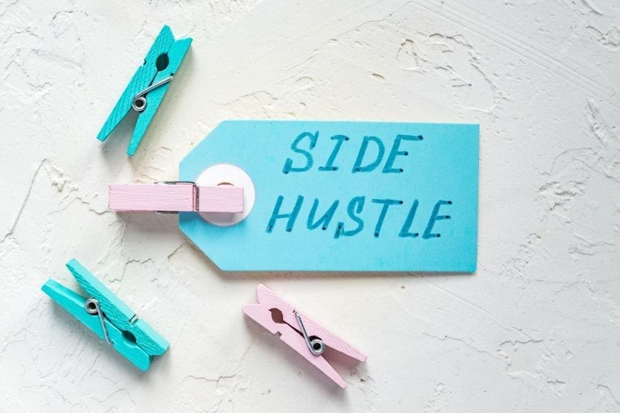 Clothes pegs featuring the phrase "side hustle" for extra cash.
