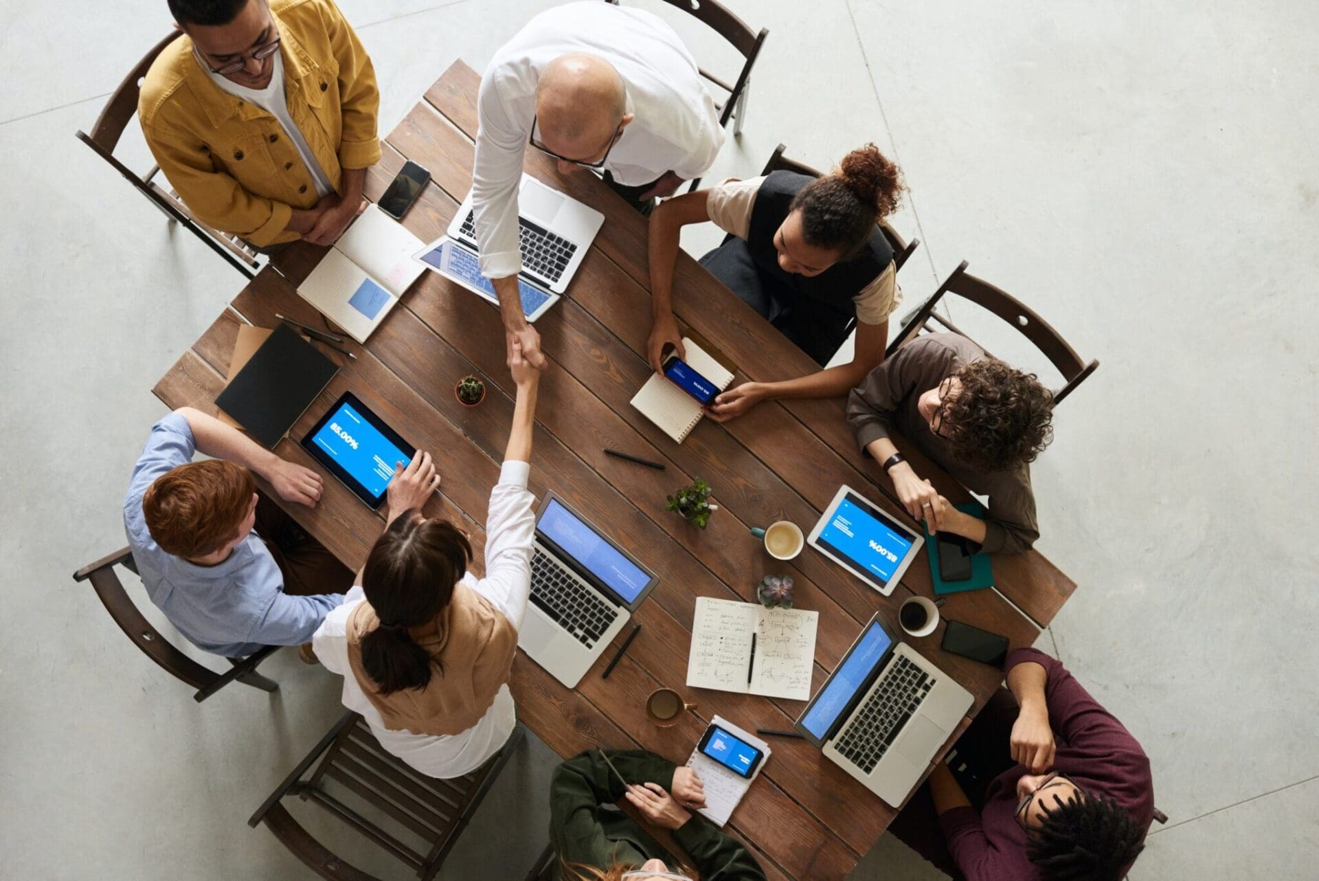 A diverse team collaboratively working and learning with laptops, fostering an inclusive and upskilling environment in 2023.