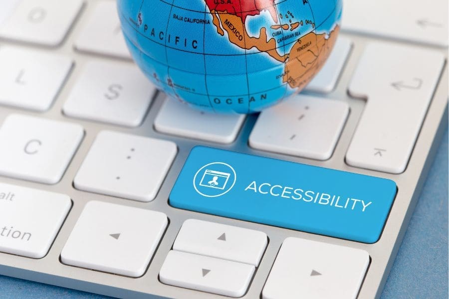 A blue globe sits on a keyboard, emphasizing the significance of creating an accessible website for people with disabilities.